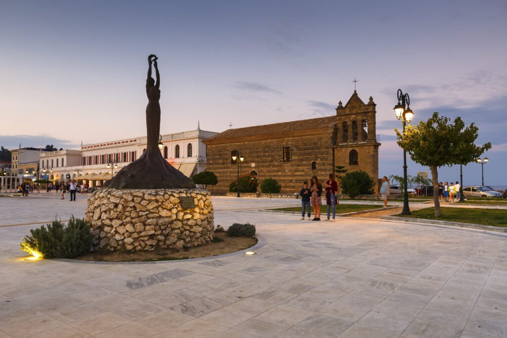 The stone facade and bell tower of St. Nicholas of the Mole church in Solomos Square, Zakynthos Town, Greece